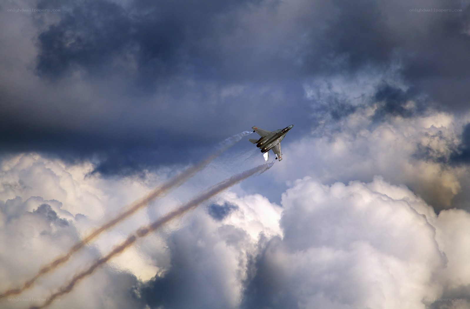 Jet fighter in cloudy sky