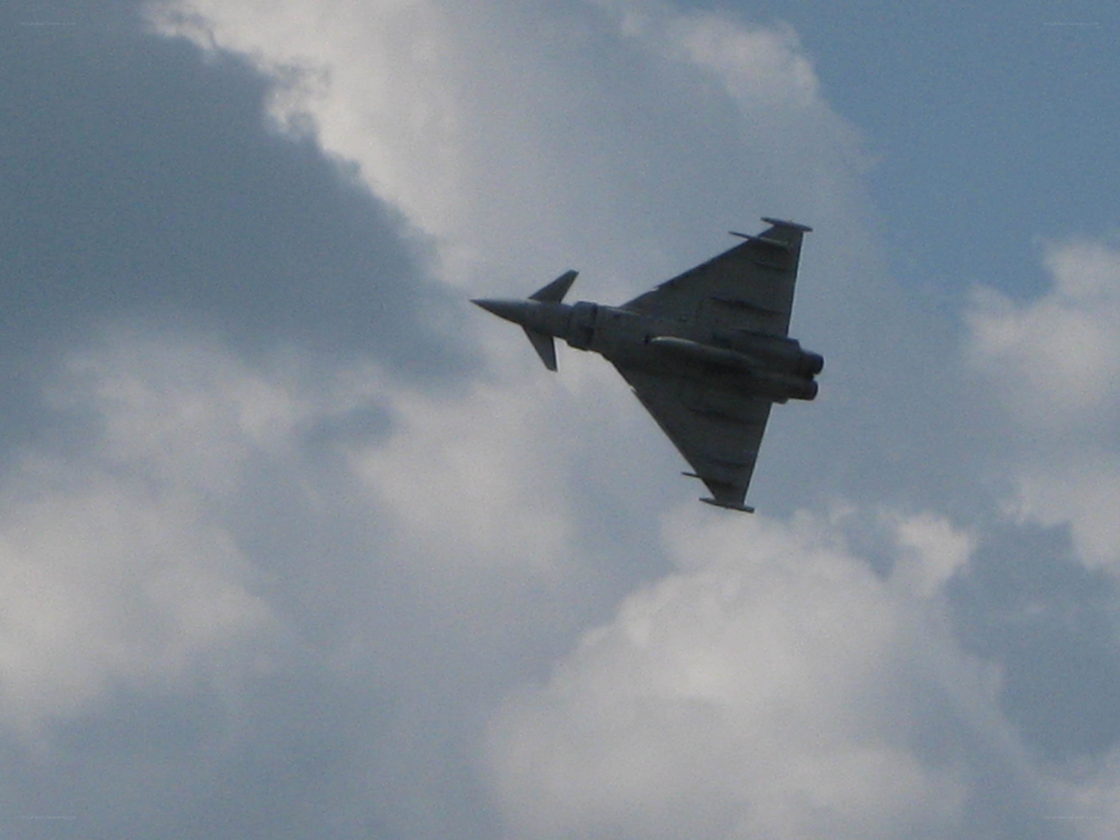Jet fighter in cloudy sky