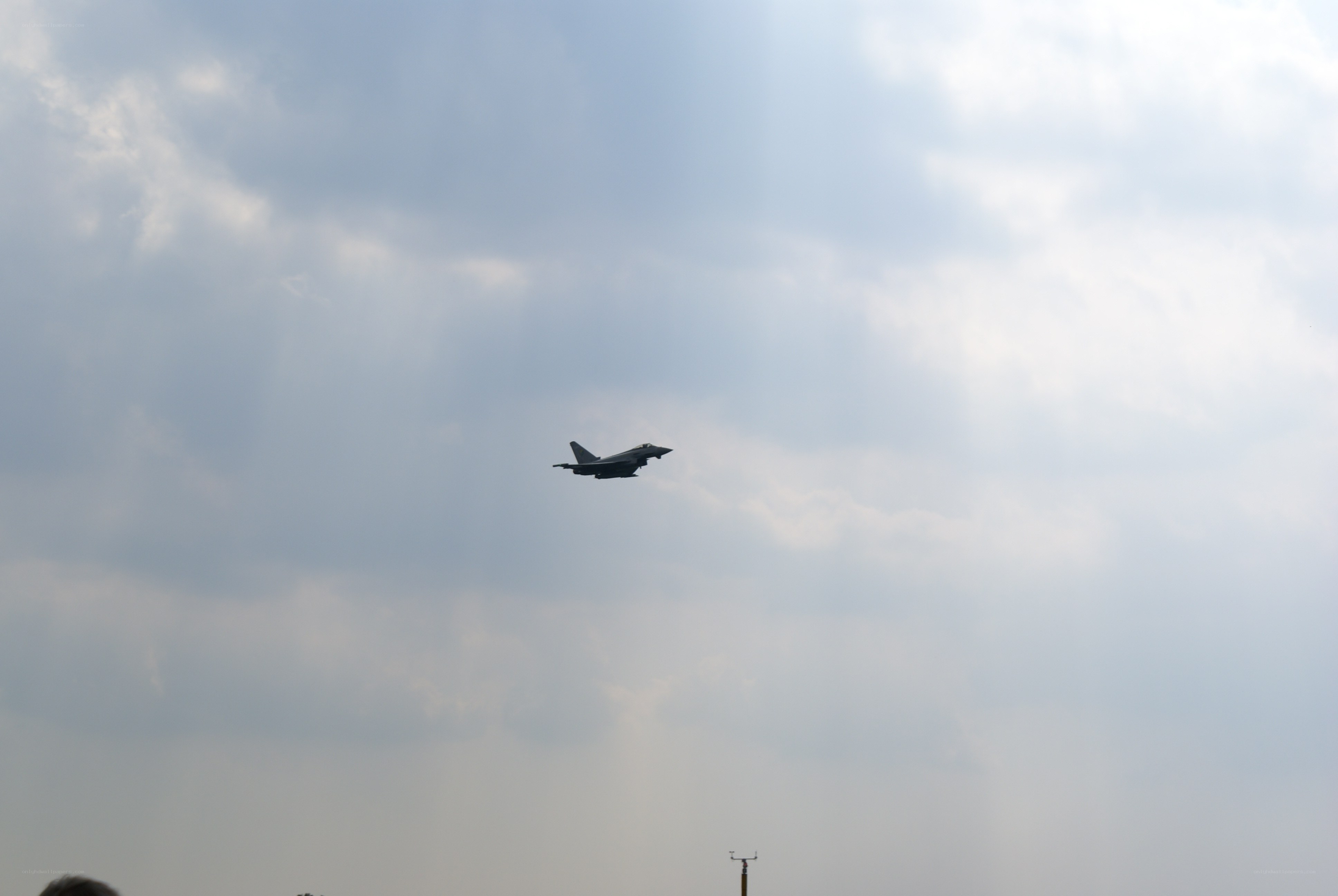 Jet fighter in cloudy sky