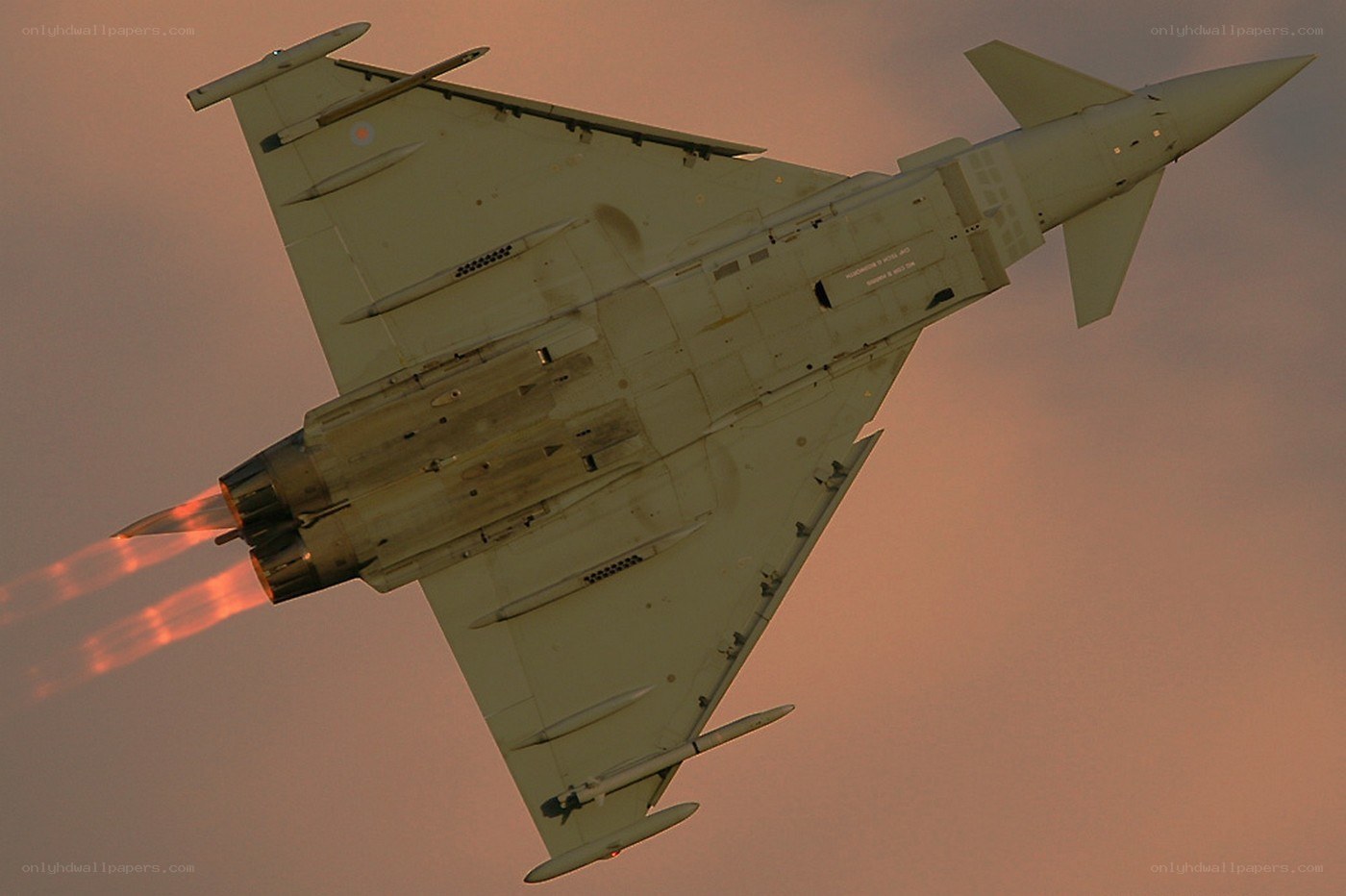 Jet fighter in flight at sunset