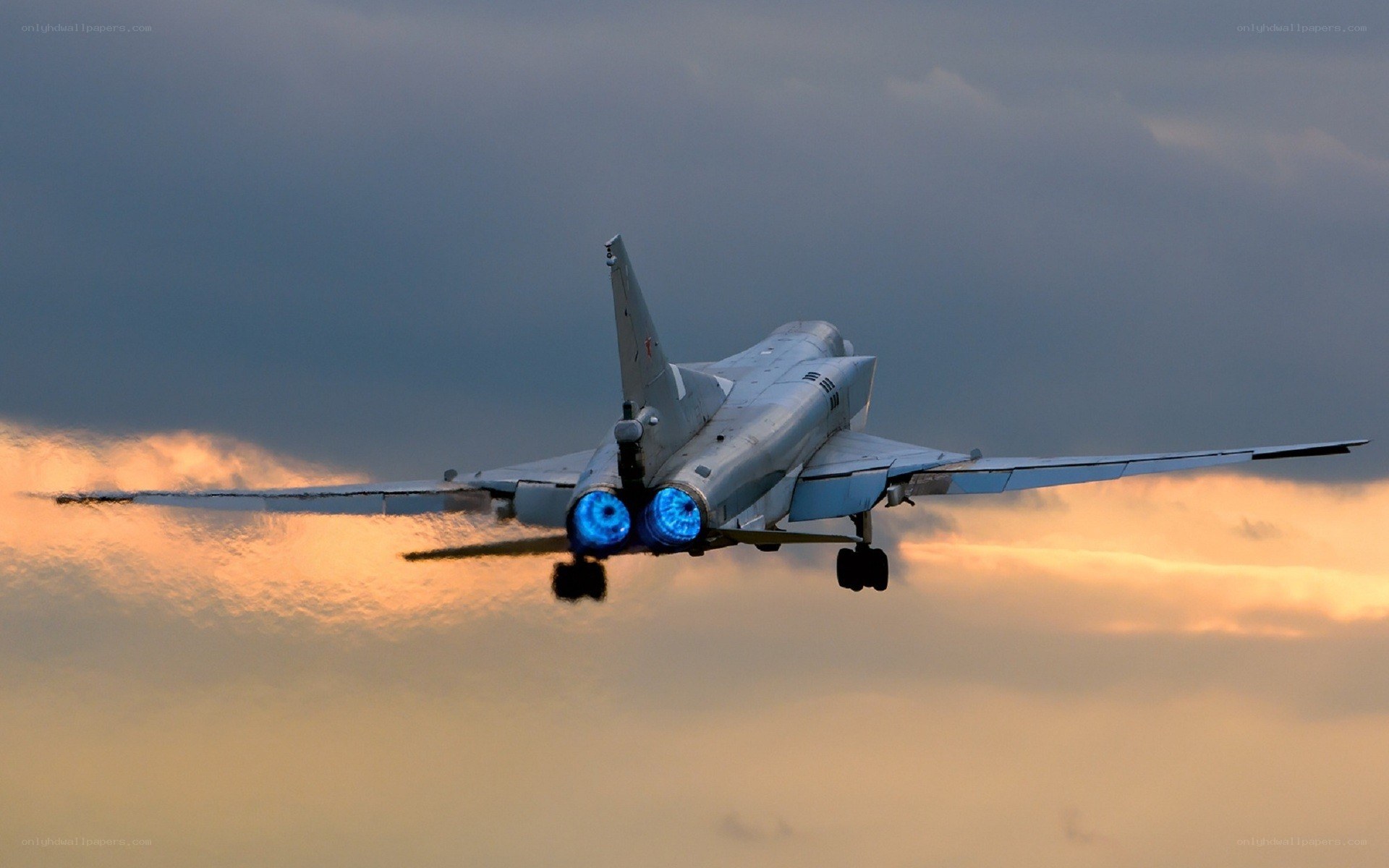 Jet fighter in flight at sunset
