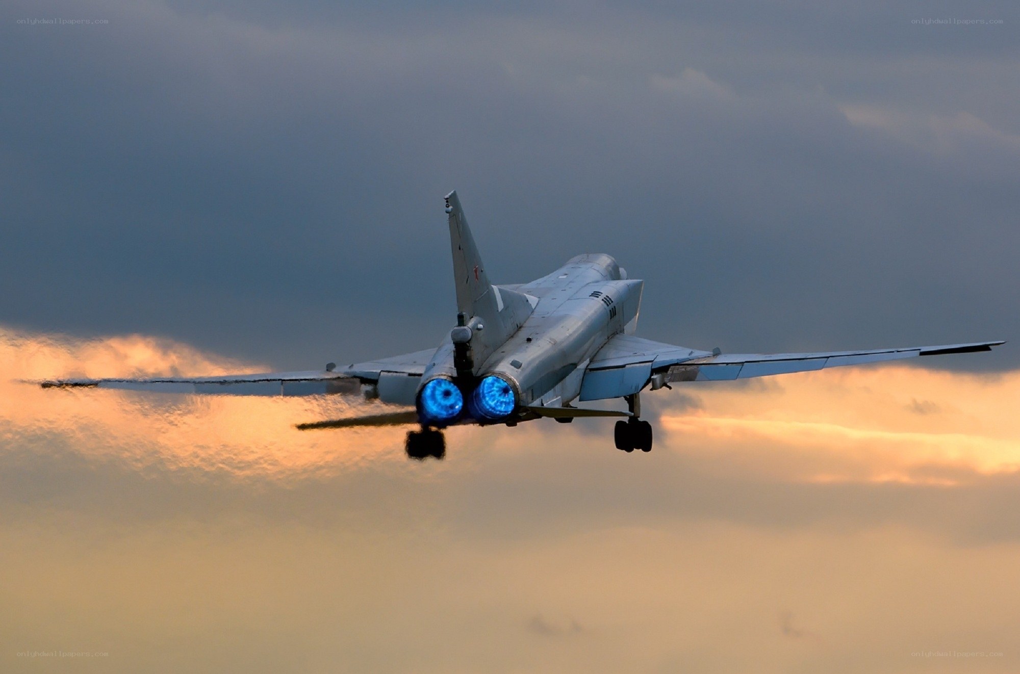 Jet fighter in flight at sunset