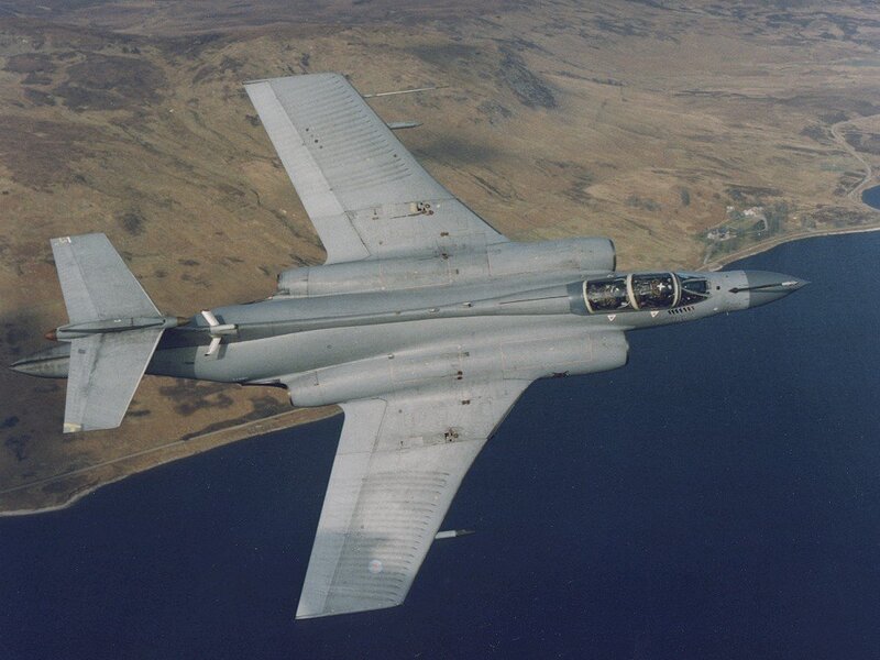 Jet fighter in flight over coast