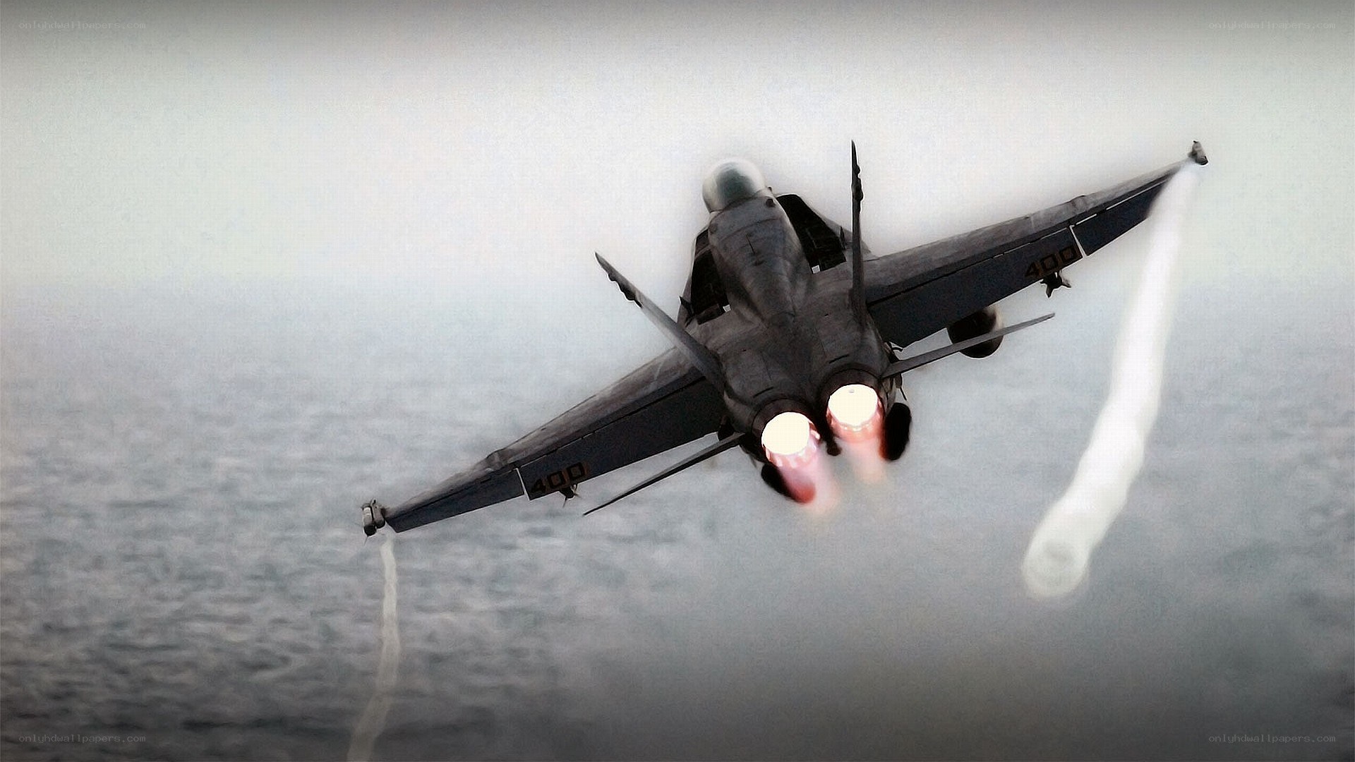 Jet fighter in flight over ocean