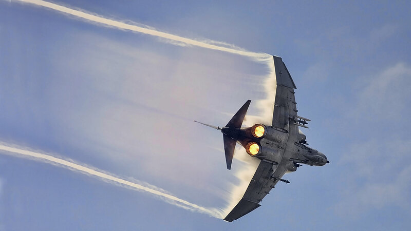 Jet fighter in flight with afterburners