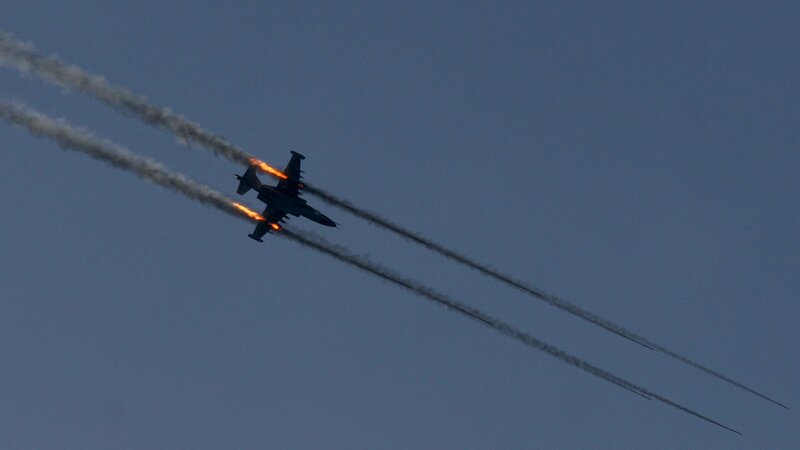 Jet fighter in flight with flares
