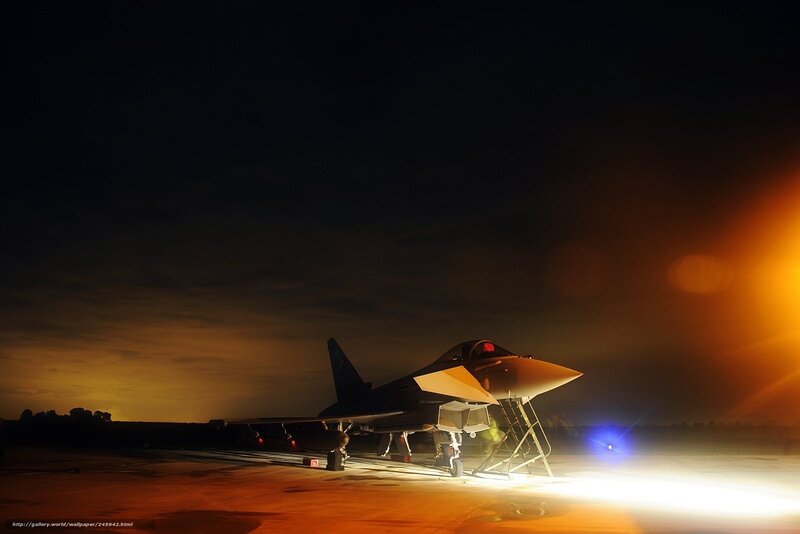 Jet fighter on tarmac at night