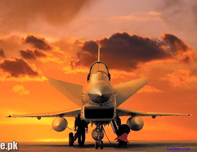 Jet fighter on tarmac at sunset