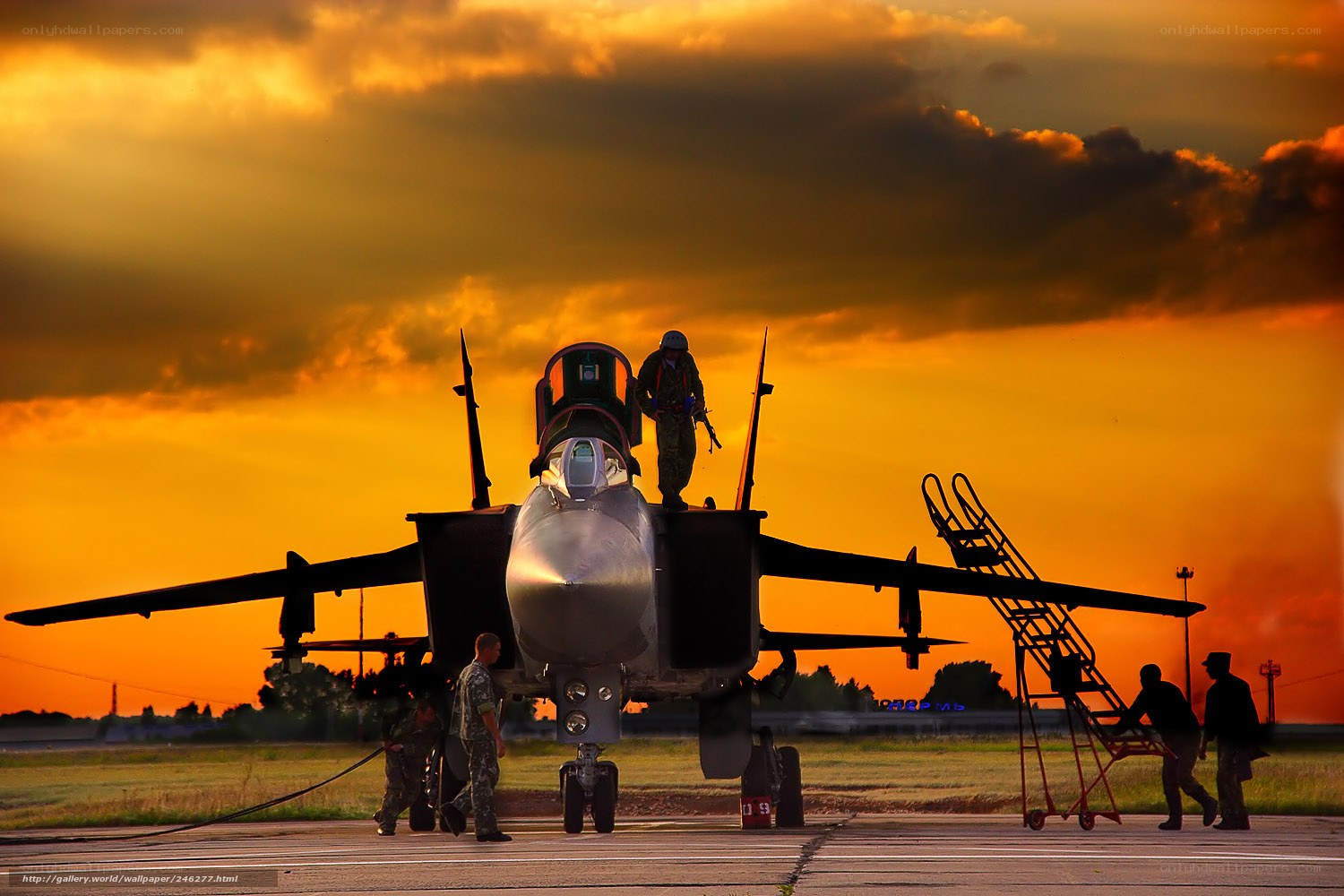 Jet fighter on tarmac at sunset