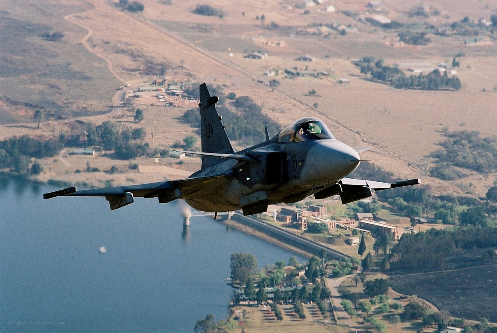 Jet fighter over a lake