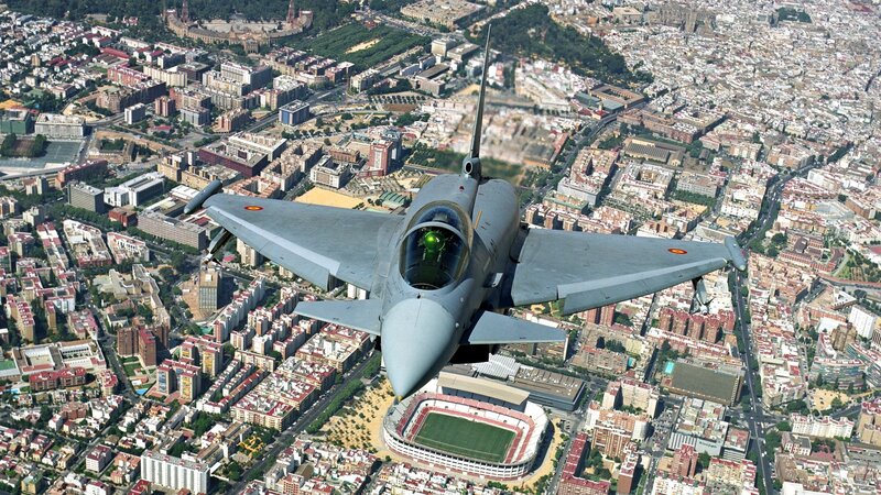 Jet fighter over city