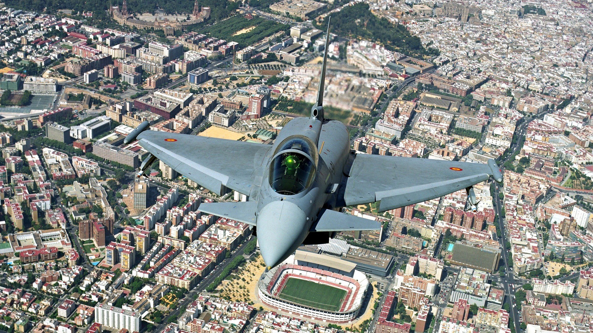 Jet fighter over city