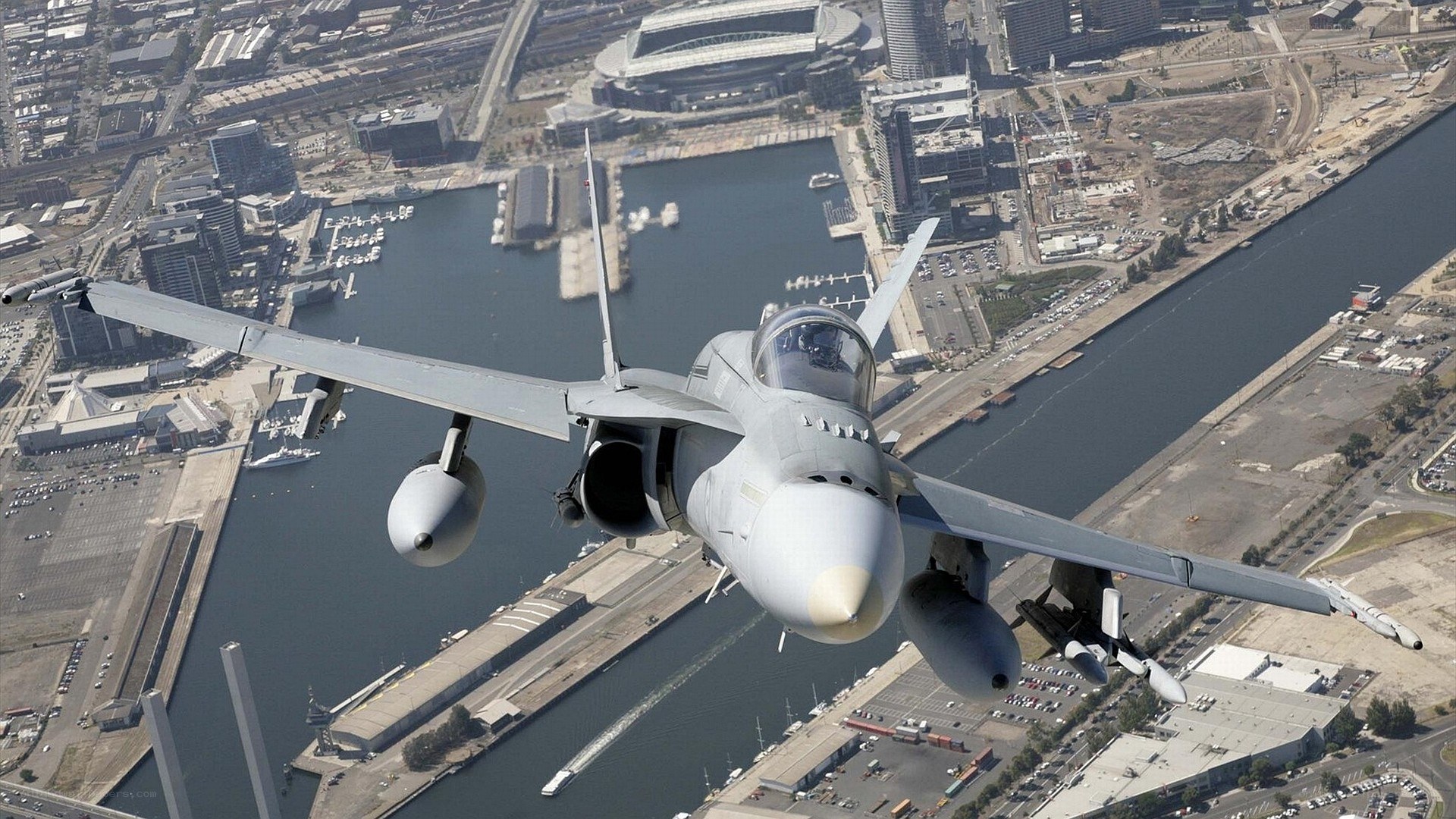 Jet fighter over city harbor