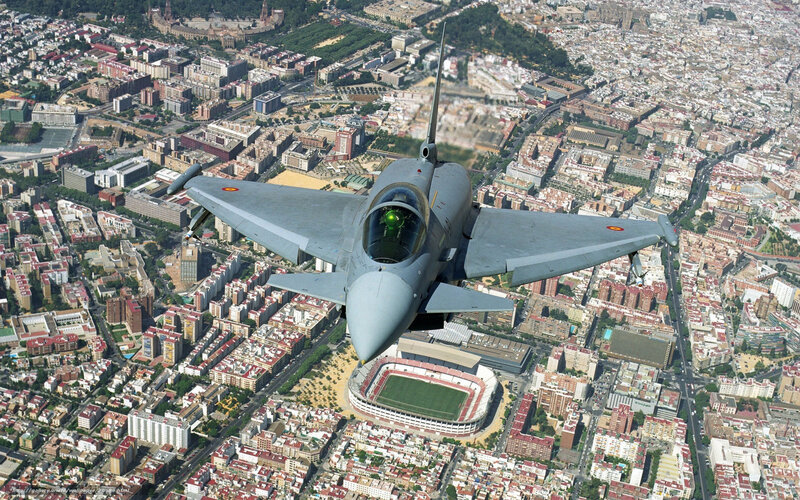 Jet fighter over city