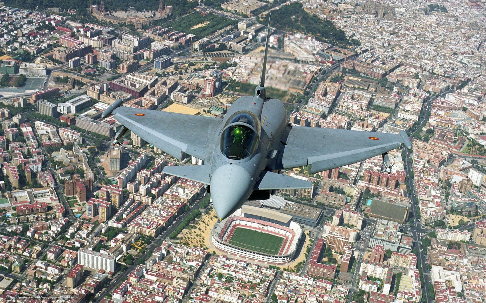 Jet fighter over city