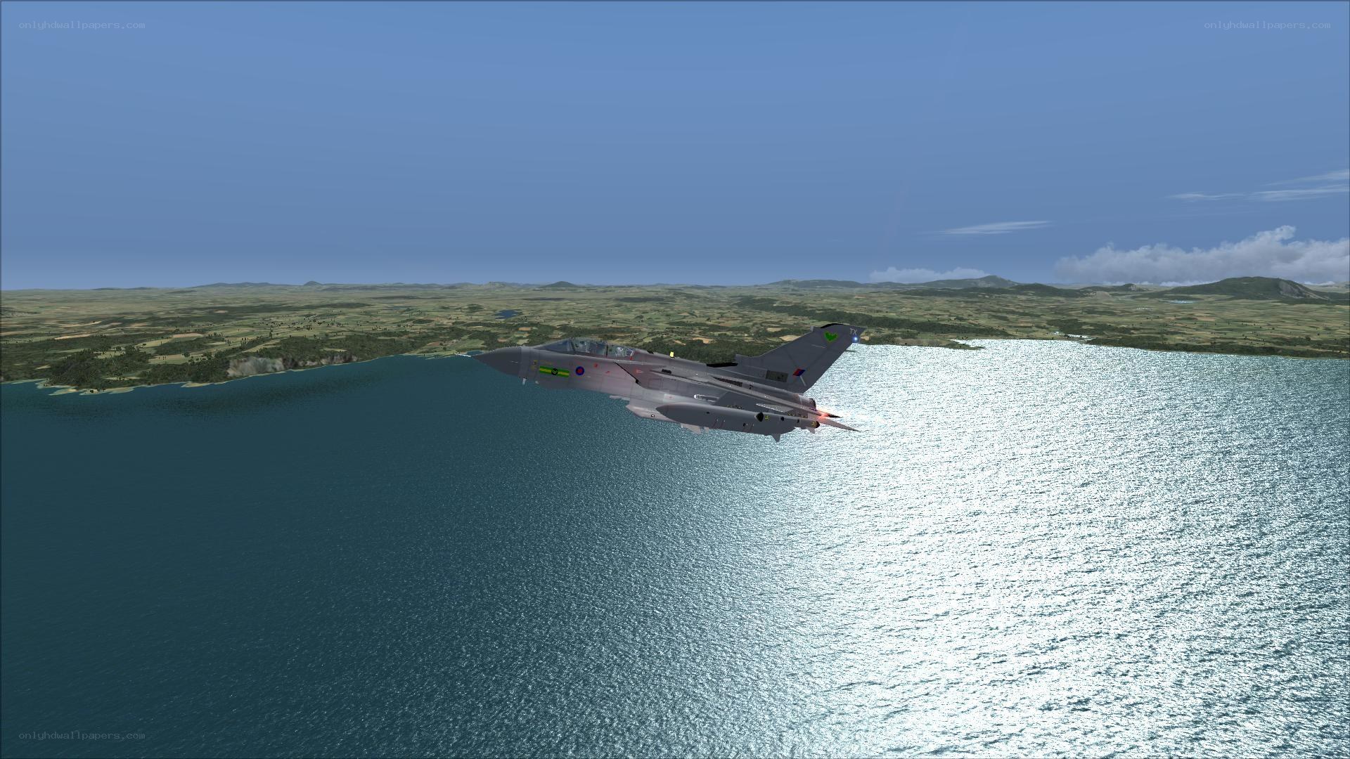 jet fighter over coastal waters