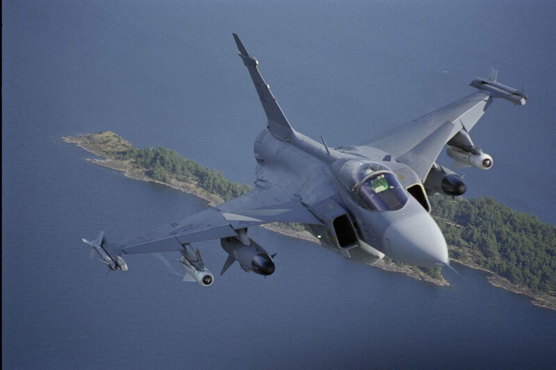Jet fighter over coastal waters
