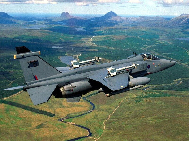 Jet fighter over mountainous terrain