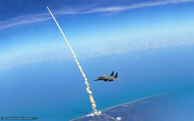 Jet fighter over rocket launch