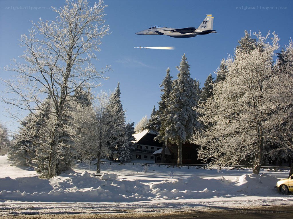 Jet fighter over snowy landscape