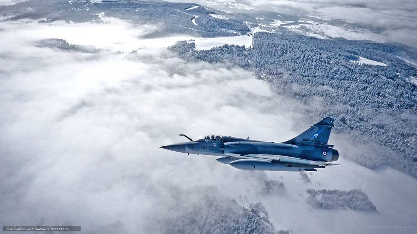 Jet fighter over snowy landscape