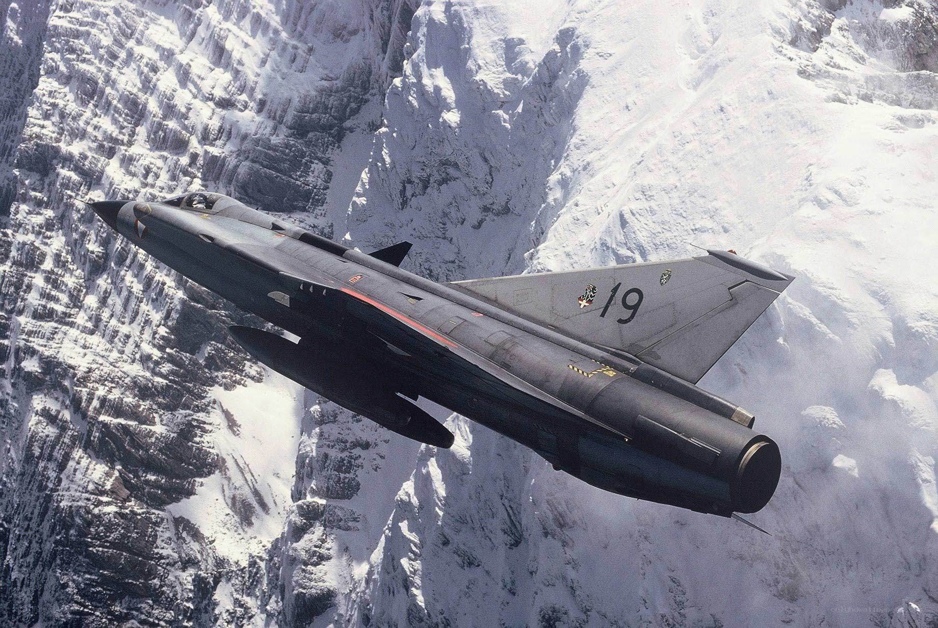 Jet fighter over snowy mountains
