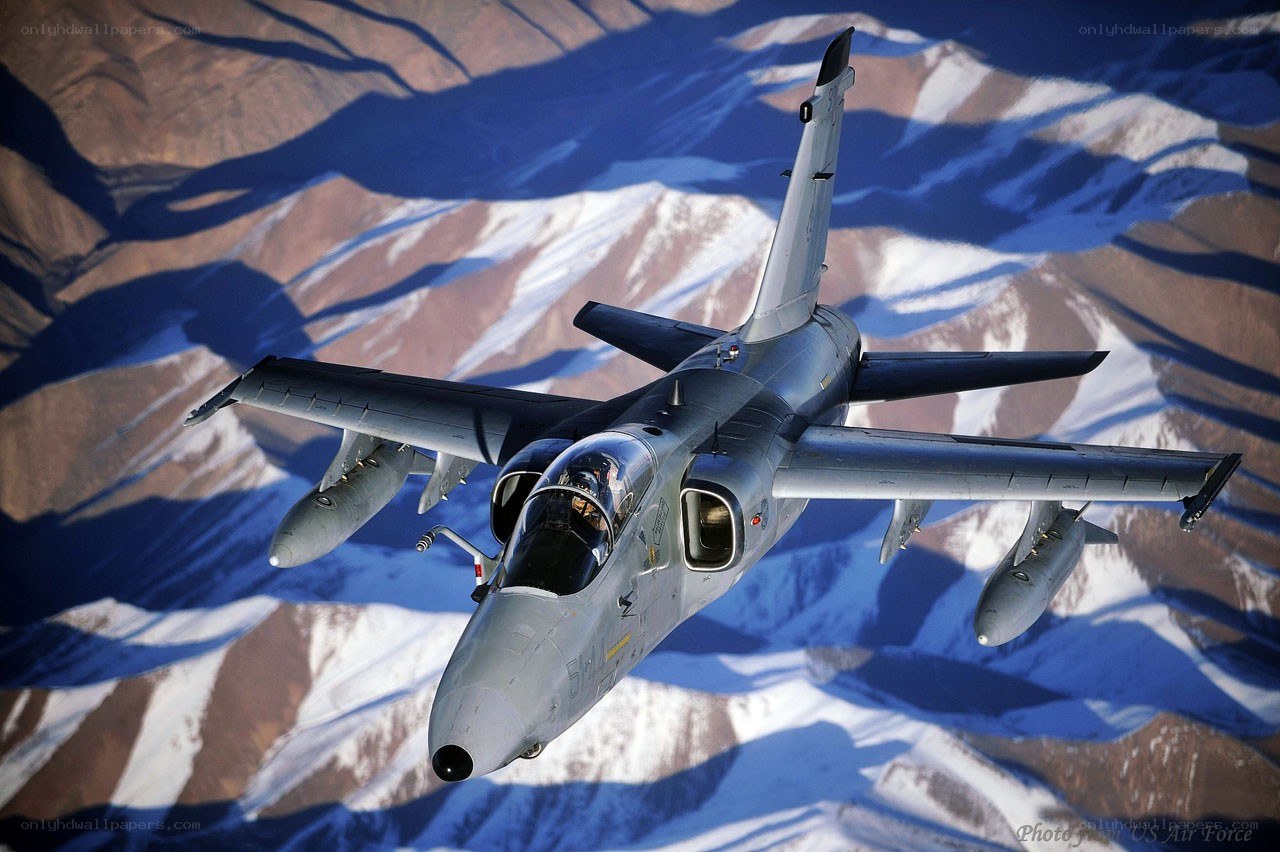 jet fighter over snowy mountains