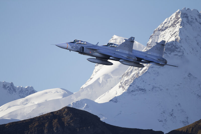 jet fighter over snowy mountains