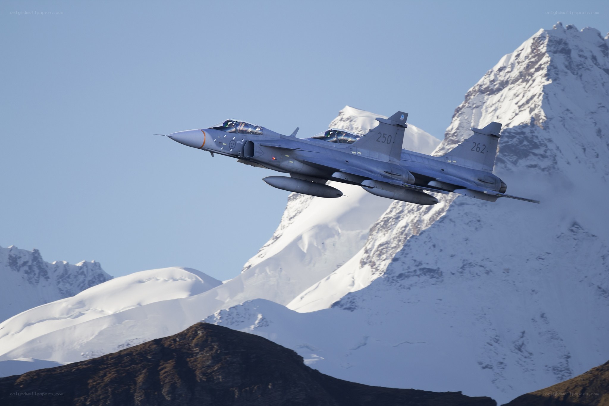 jet fighter over snowy mountains