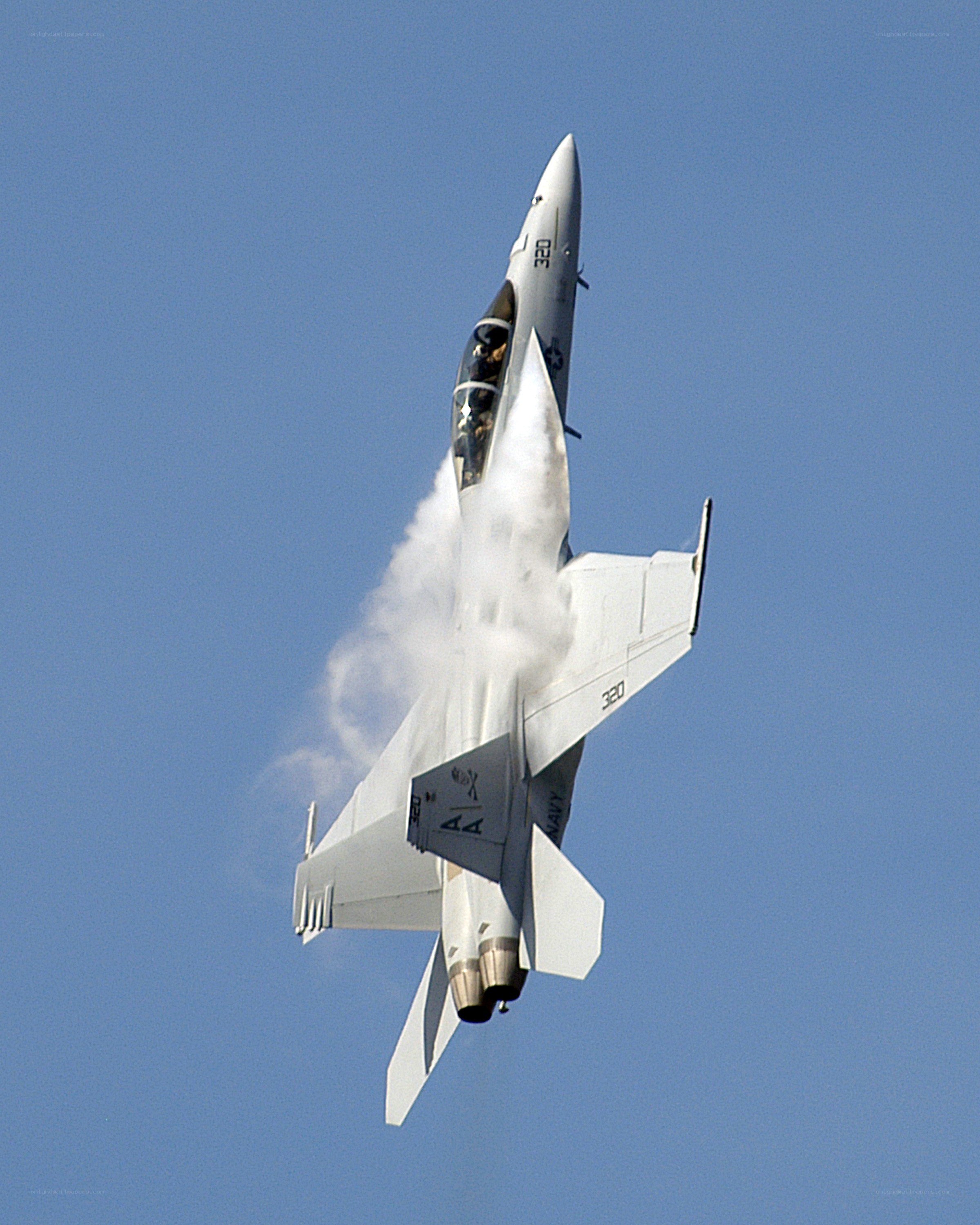 Jet fighter performing aerobatic maneuver