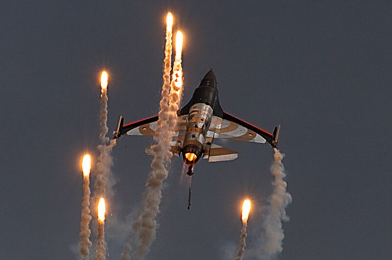 Jet Fighter Releasing Flares — Gray