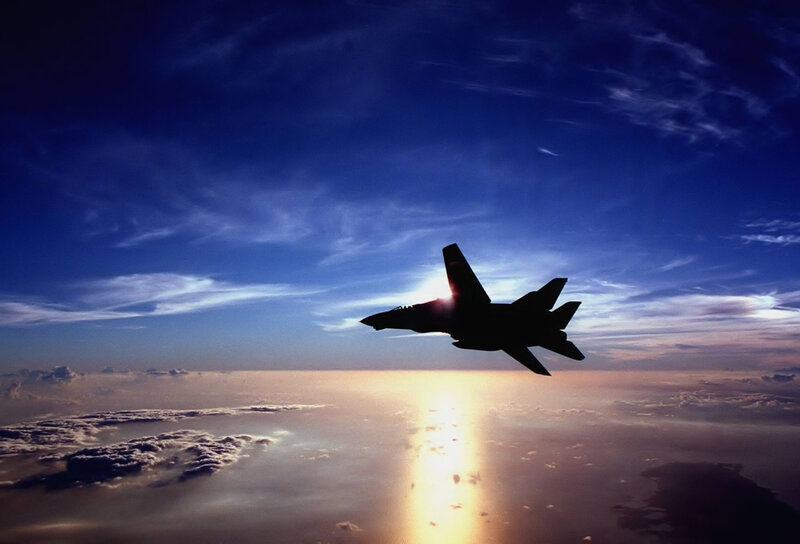 Jet fighter silhouette at sunset