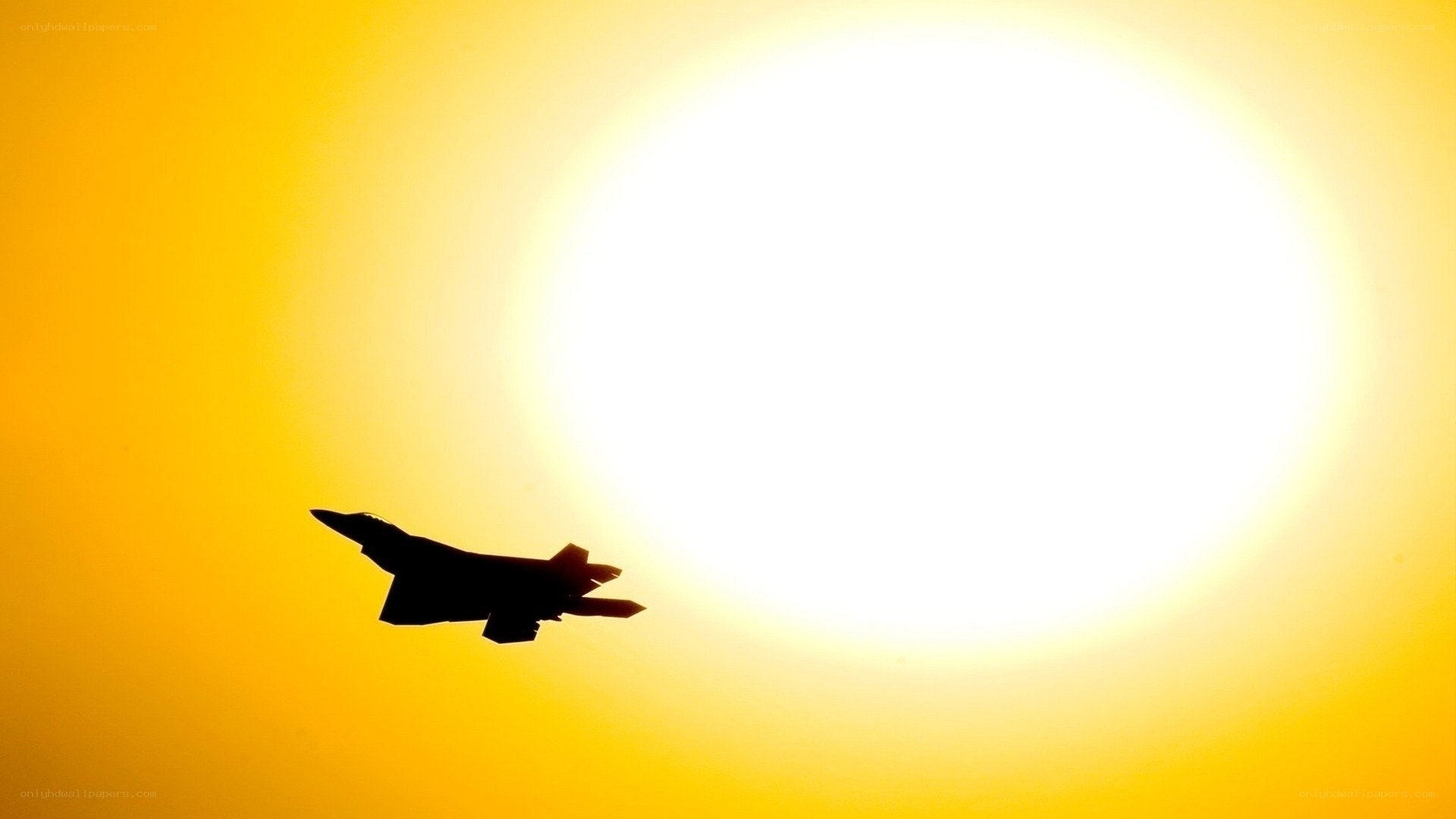 Jet fighter silhouette at sunset