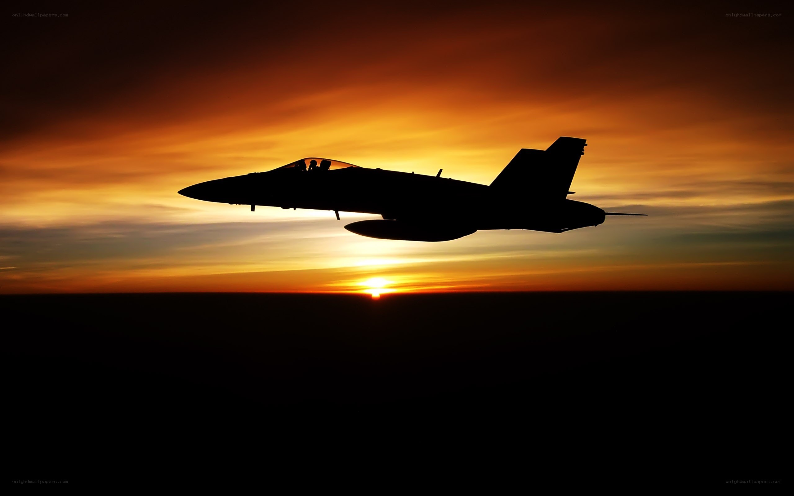 Jet fighter silhouette at sunset