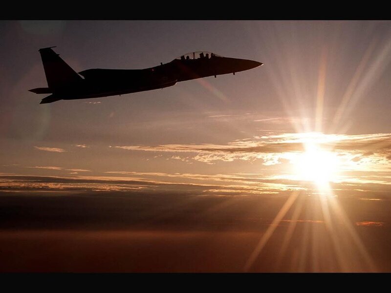 Jet fighter silhouette at sunset