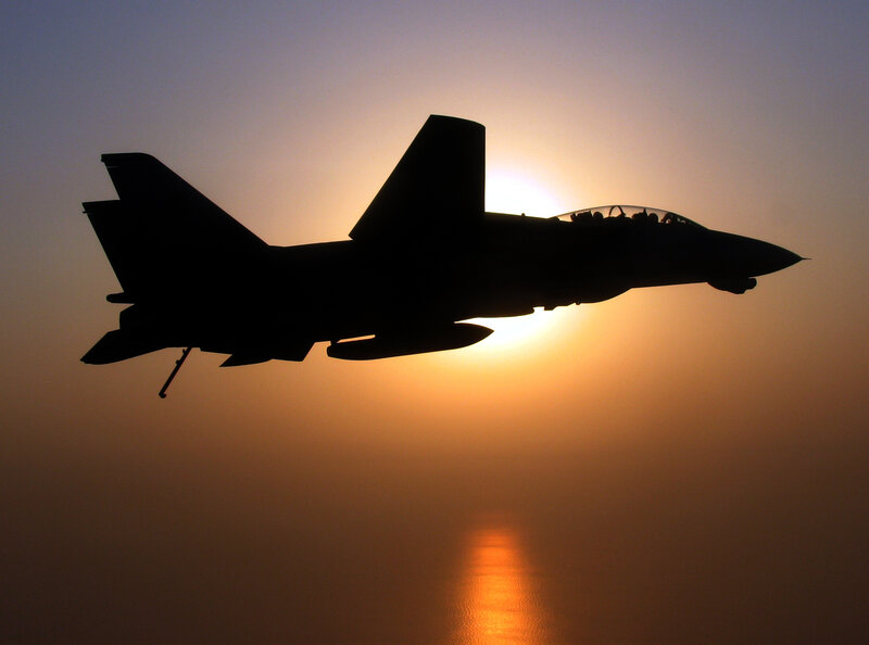 Jet fighter silhouette at sunset