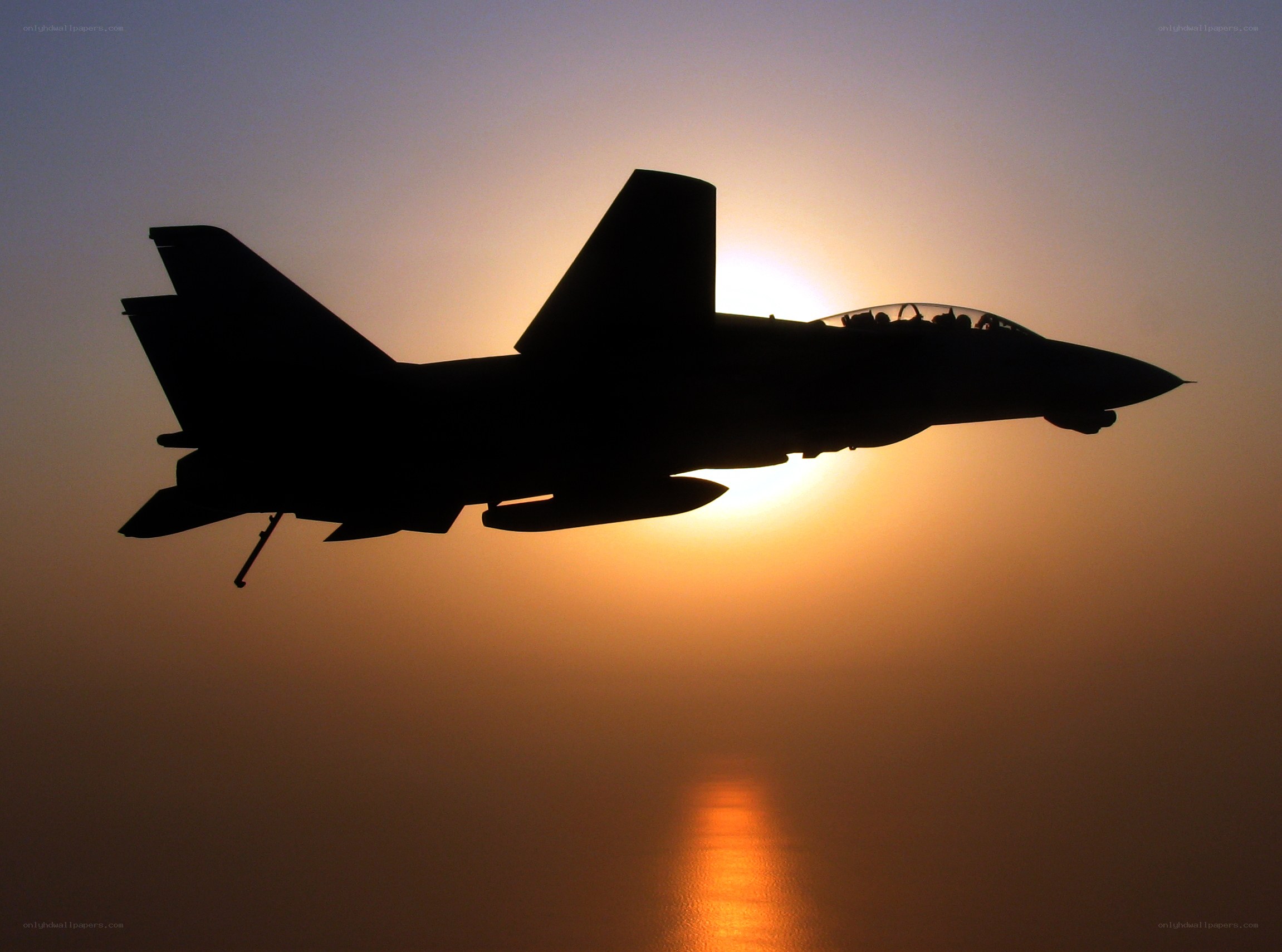 Jet fighter silhouette at sunset