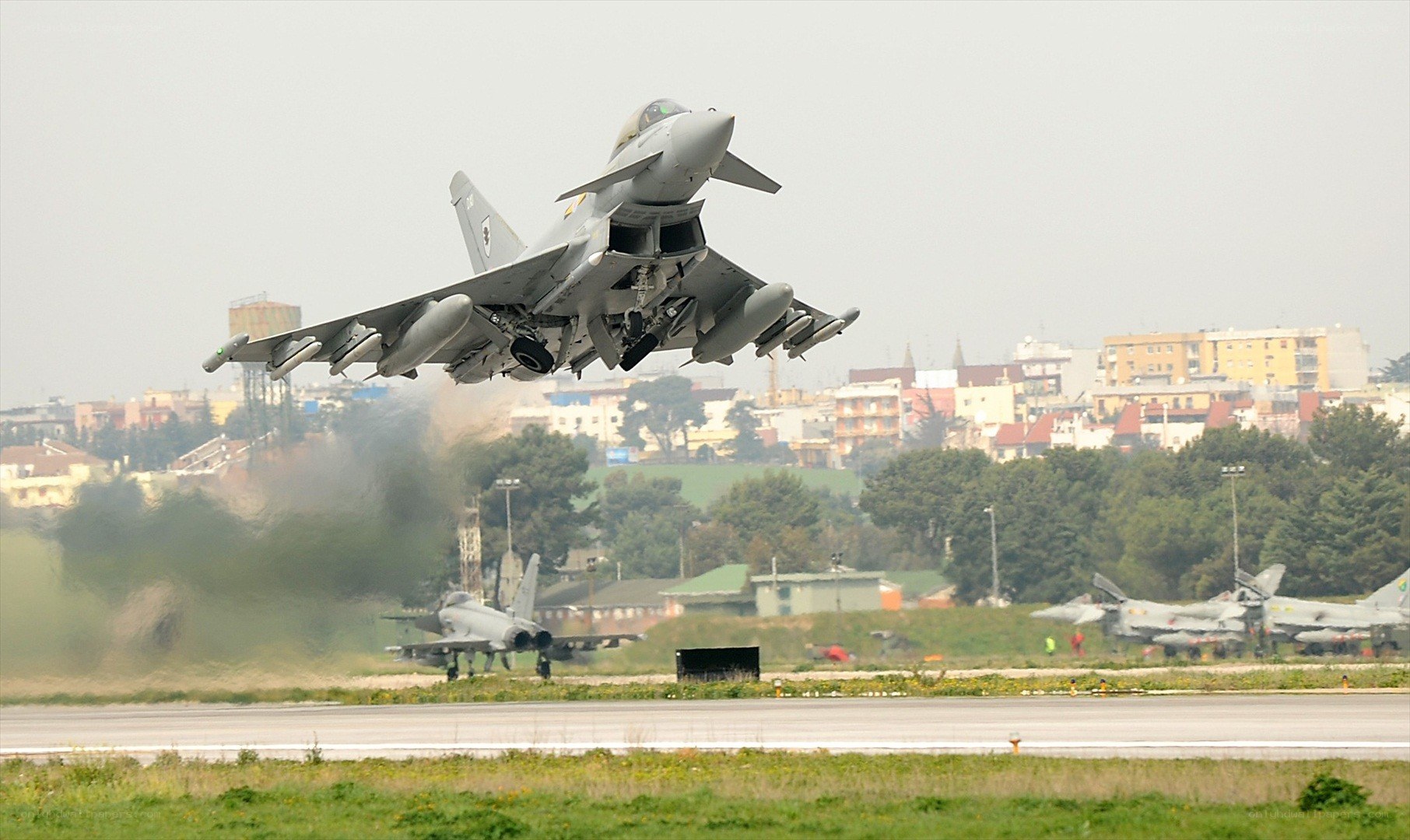 Jet fighter taking off from runway