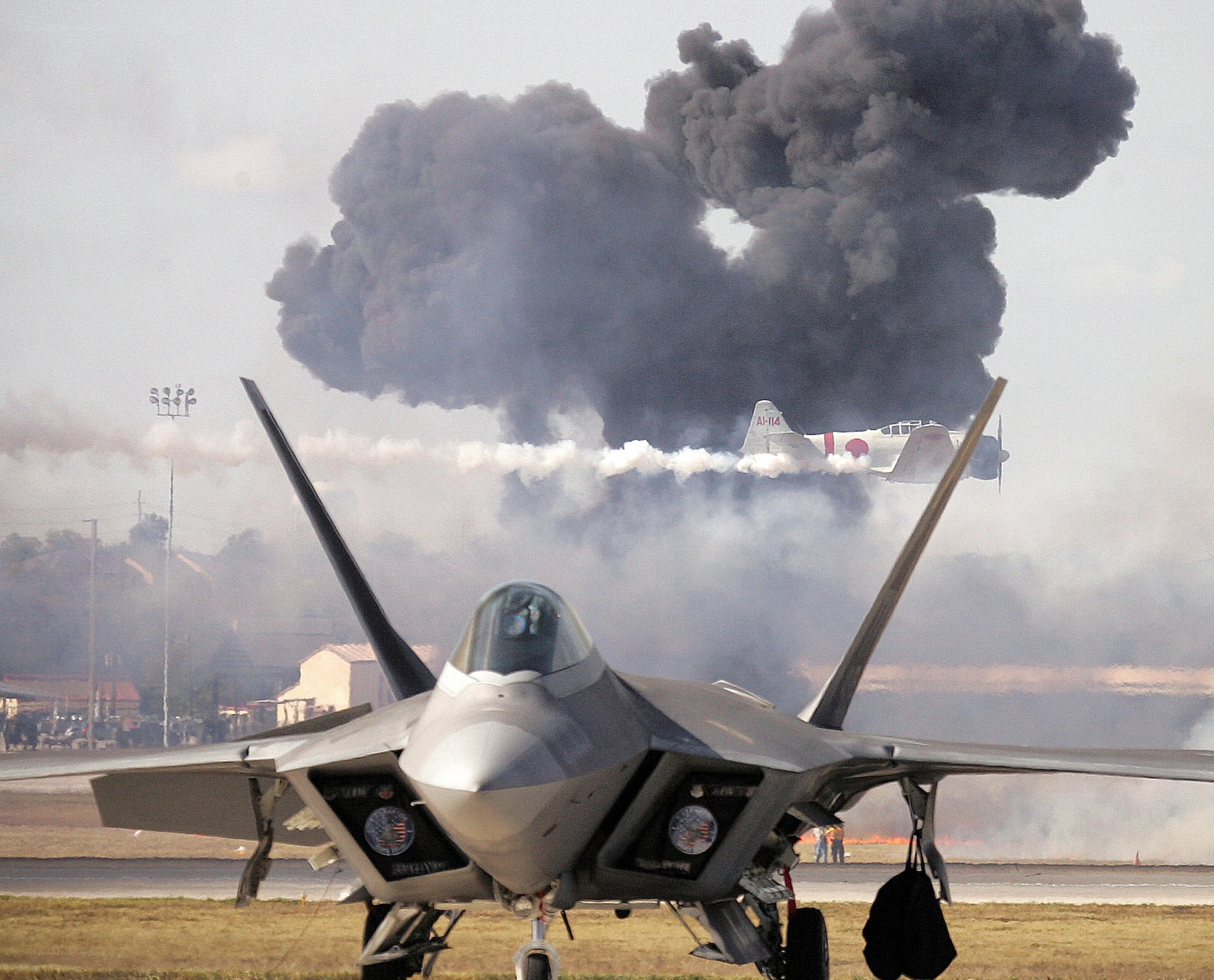 Jet fighter with smoke plume