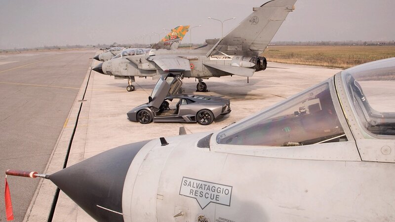 Jet fighters and supercar on tarmac