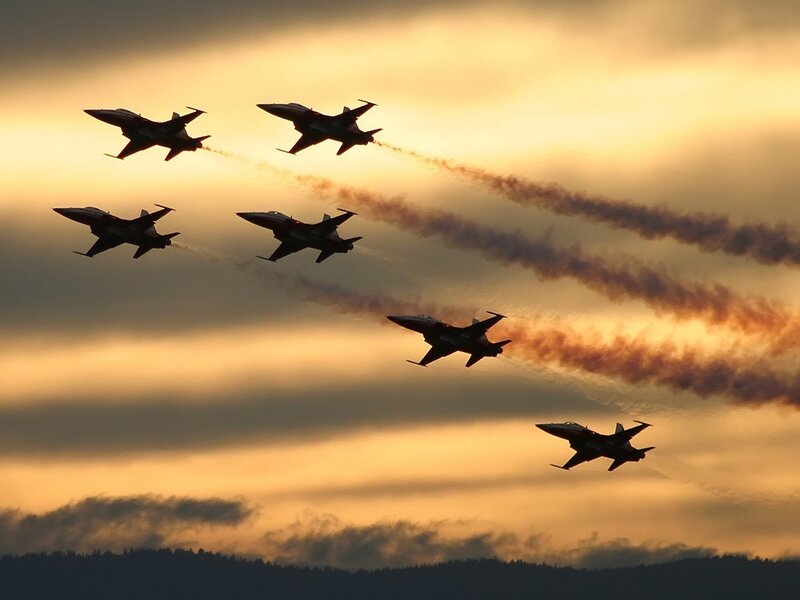 Jet fighters in formation at sunset