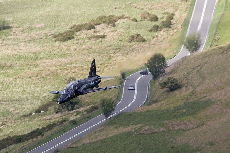 Jet flying over a winding road