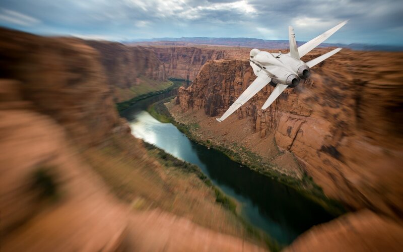 Jet Flying over Canyon