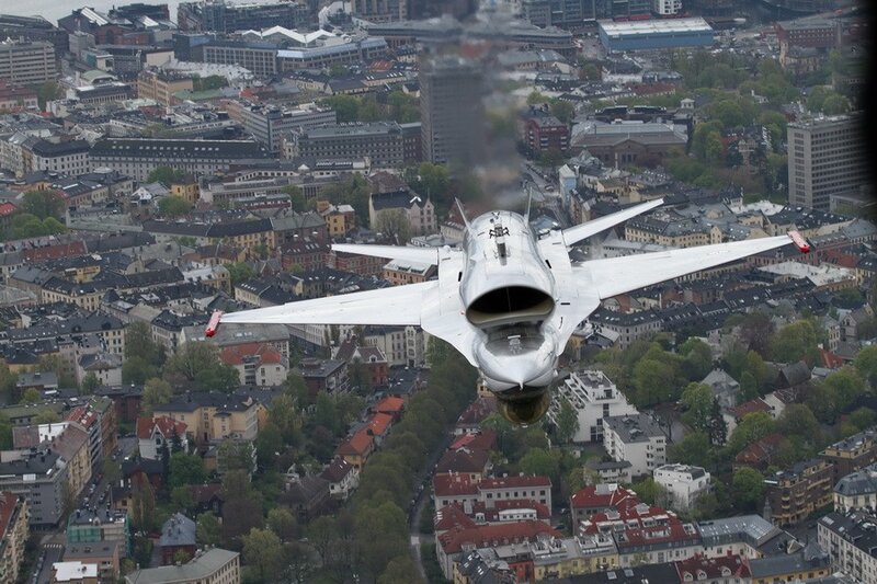 Jet flying over city