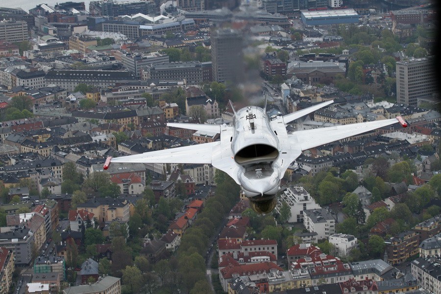 Jet flying over city