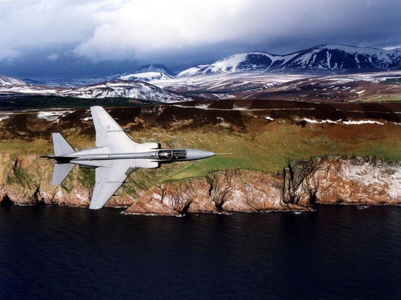 jet flying over coastal mountains