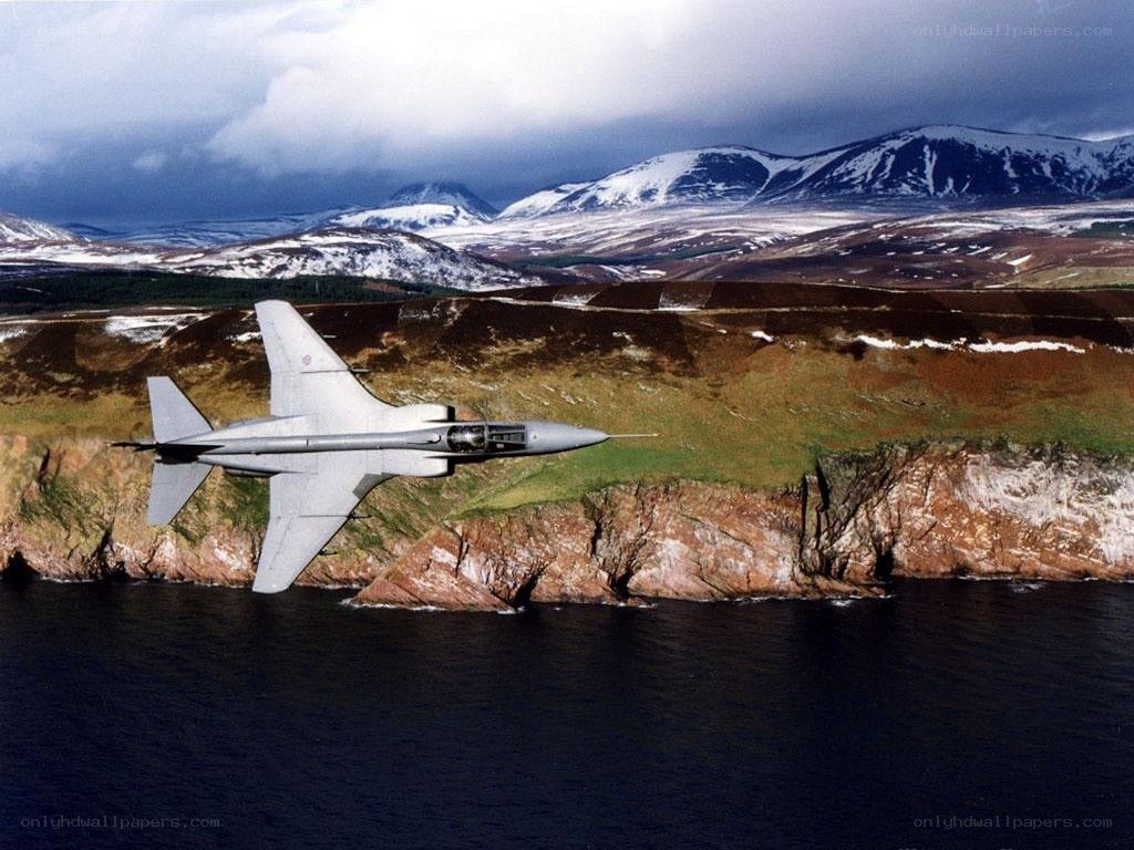 jet flying over coastal mountains