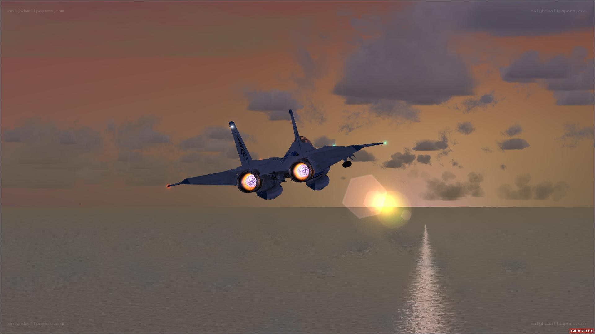jet flying over ocean at sunset