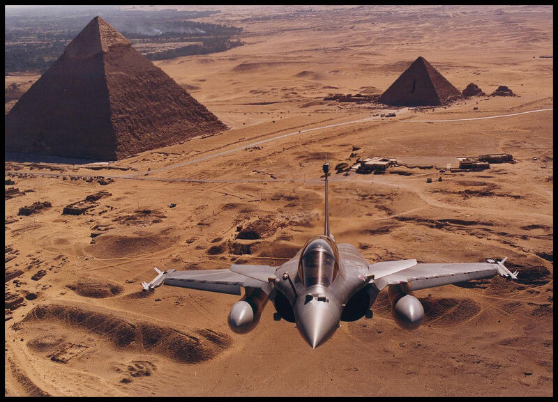 Jet flying over pyramids