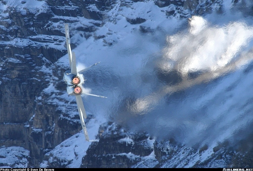 Jet flying over snowy mountains